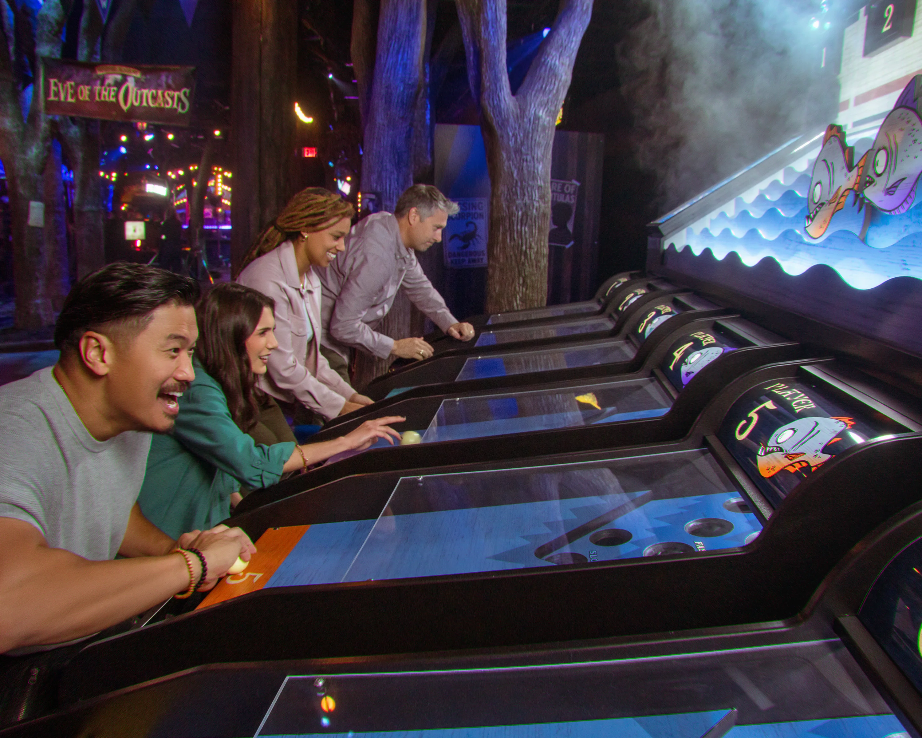 A group of 4 young professionals compete in a carnival game at the Wednesday experience.