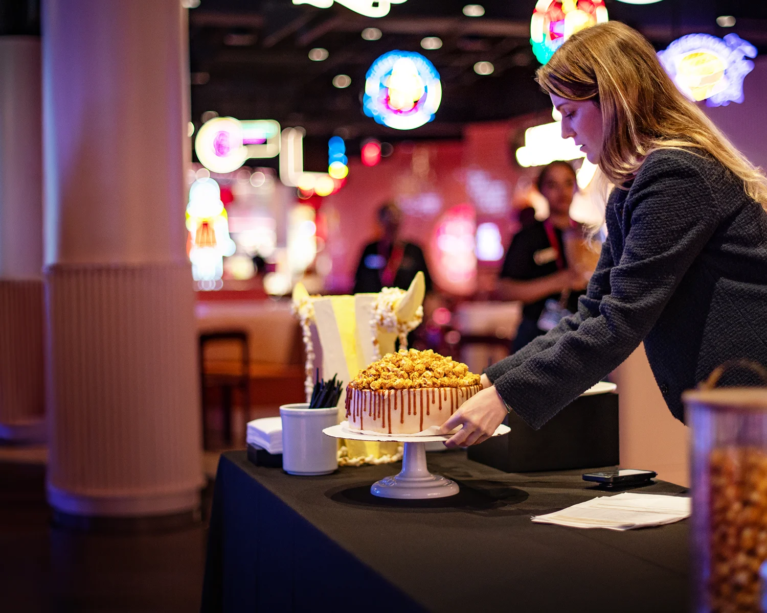 A woman setting up a custom food spread at a Netflix House private event.